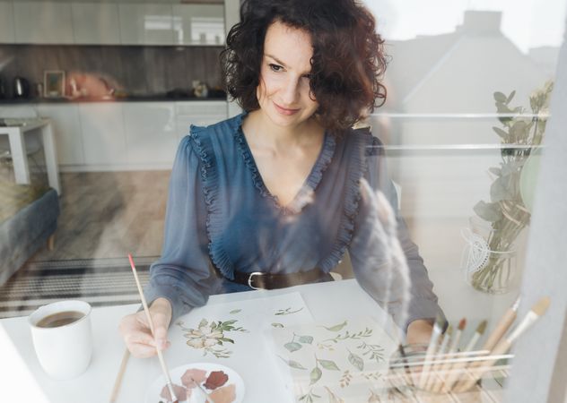 Woman painter working at home