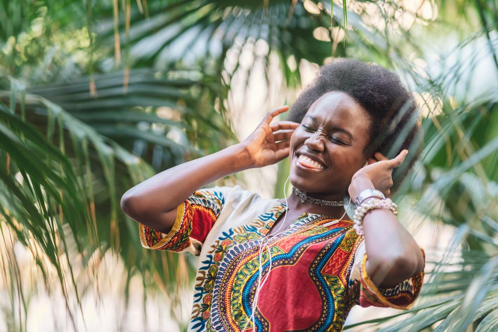 Smiling Black woman listening to music