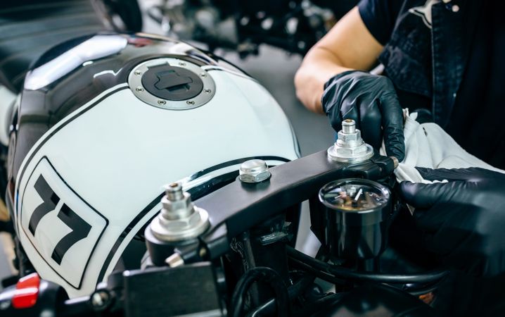 Mechanic cleaning a motorcycle