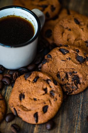 Coffee surrounded by chocolate chip cookies