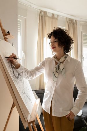 Person drawing city on canvas