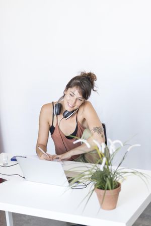 Smiling female working at home desk