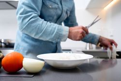 Cropped shot of man prepping seafood in kitchen