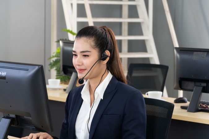 Woman speaking on headphones in business call center