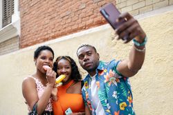Three friends taking a selfie while eating ice cream
