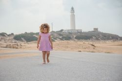 Little girl walking on beach seashore