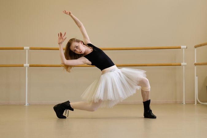 Ballerina in shoes and tutu, arching back