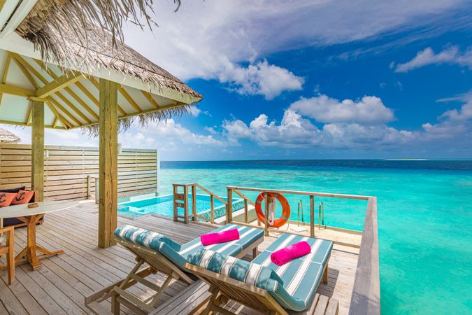 Two lounge chairs overlooking the Indian Ocean on a private patio