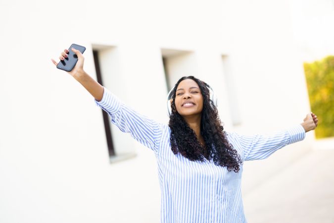 A Joyful Celebration A Young Woman Fully Relishing Life and Enjoying Nature Outdoors