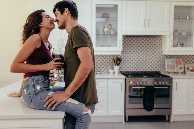 Young couple romancing in kitchen
