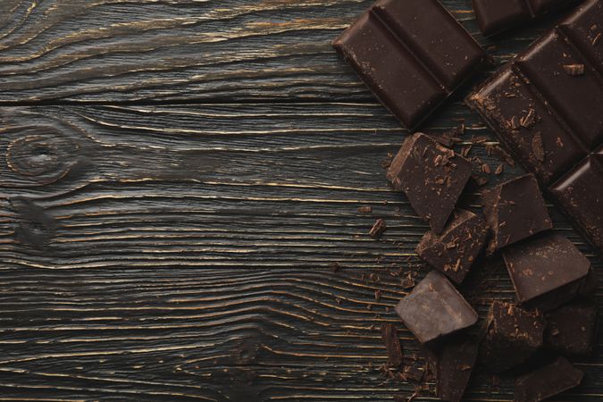 Tasty chocolate on wooden background, top view