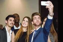 Colleagues at work taking a selfie in the office