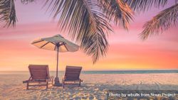 Beautiful gradient sunset with two reclining chairs and parasol 4Zvxx4