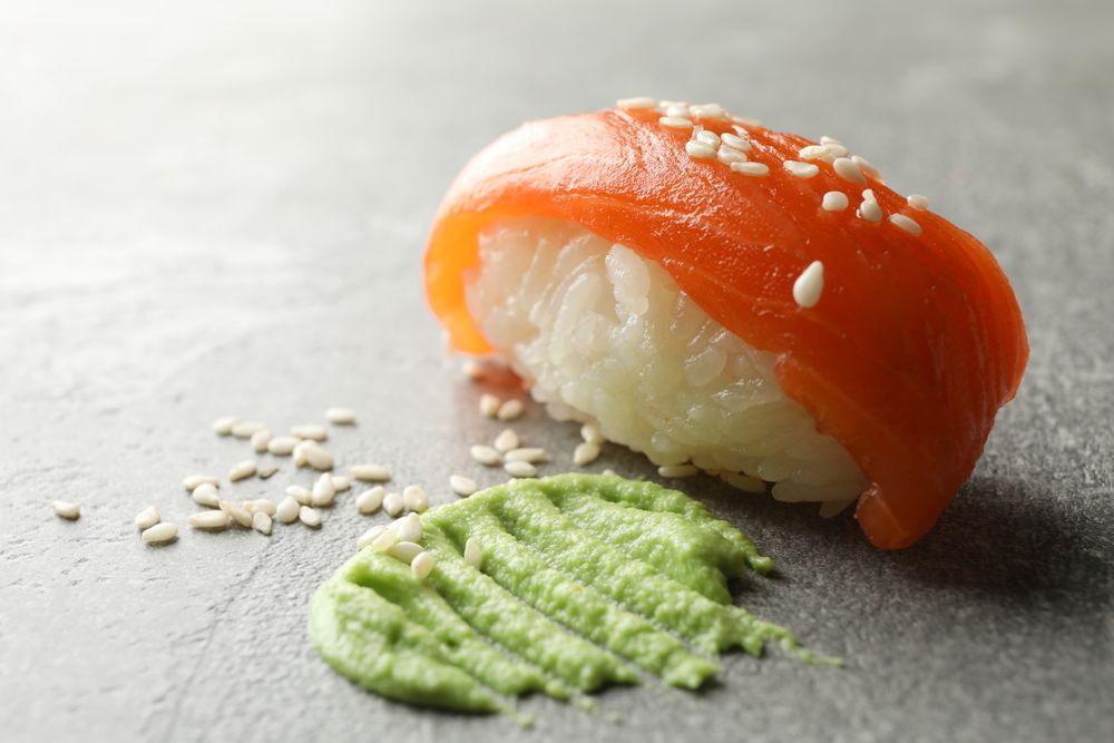 Delicious sushi roll and wasabi on gray background. Japanese food