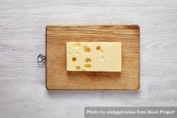 Swiss cheese on wooden board 0Wrejb