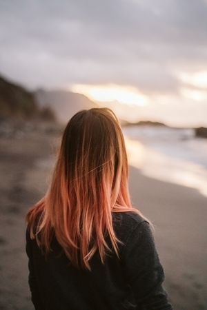 Anonymous woman standing near sea