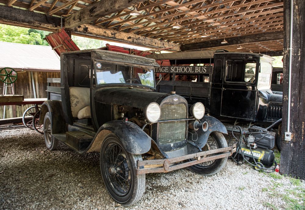 An old farm truck and a vintage school bus at Heritage Farm Museum, Harveytown, West Virginia