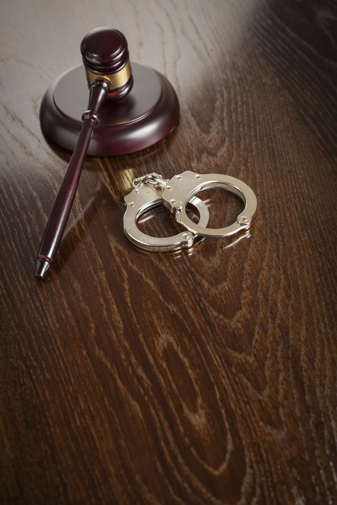Gavel and Pair of Handcuffs on Table