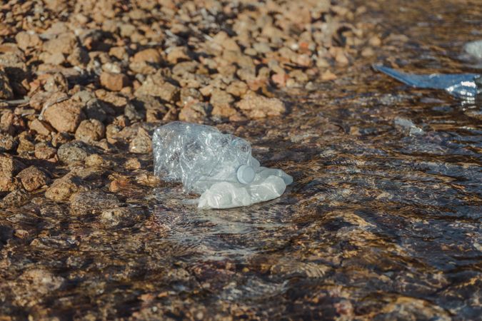 Plastic bottle lying on seashore