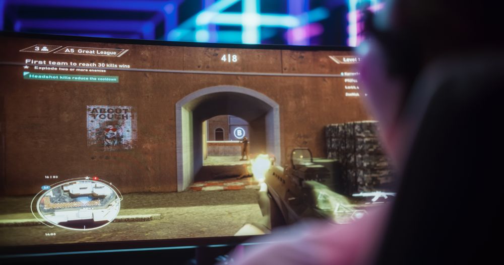 Close Up of a Female Gamer Playing First-Person Shooter Online Video Game on a Computer.