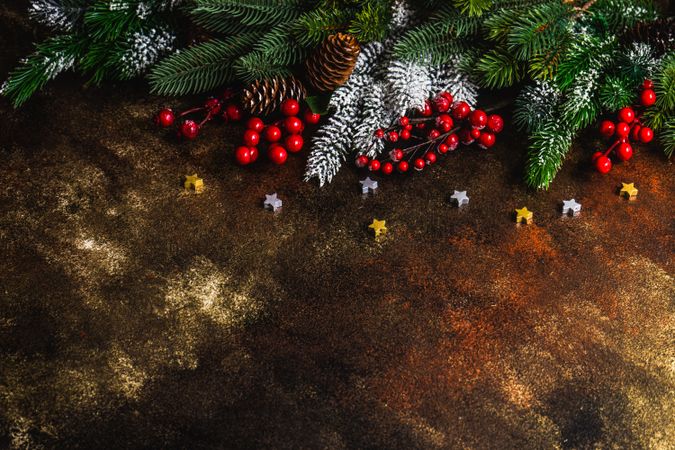 Christmas holiday concept of pine and holly on golden table