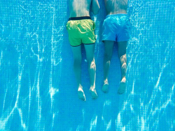 Faceless kids in swimming pool