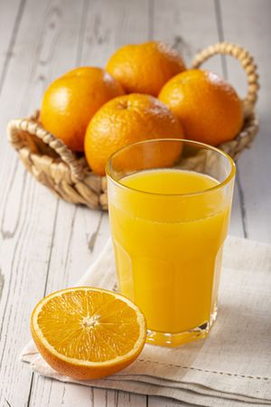 Glass with orange juice on the table.