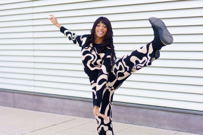 Woman kicking artfully outside