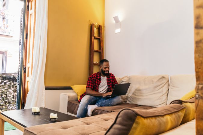 Black man using laptop at home