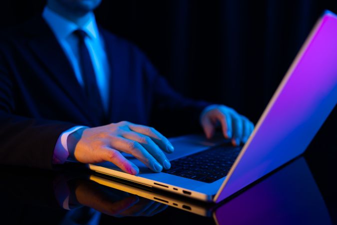 Futuristic Businessman at Laptop Desk