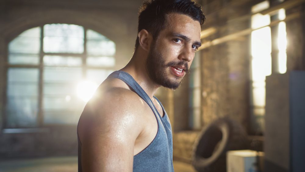 Exhausted Muscular Man Looking into Camera after Exhausting Gym Workout.