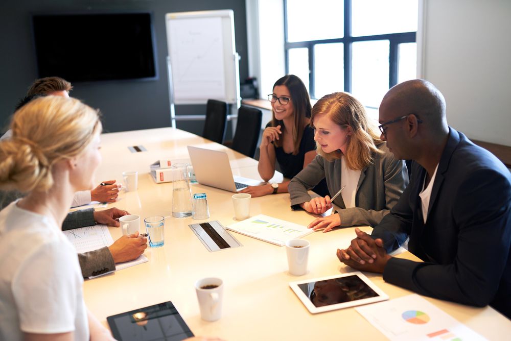Business colleagues having a meeting discussing graphs and figures