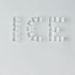 Ice cubes making “ICE” word on bright background
