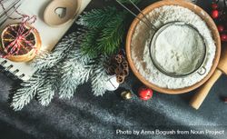 Top view of flour with sieve for Christmas baking on dark counter bePMp4