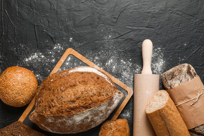 Bakery products composition on dark background, top view and space for text
