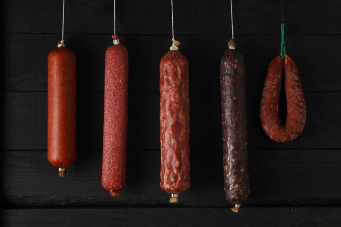 Variety of sausages hanging in a row