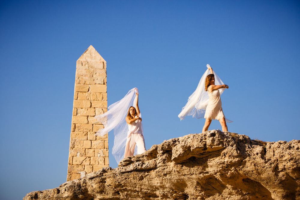 Young women with textile on stone