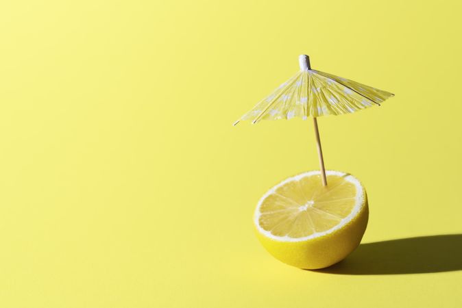 Lemon fruit and cocktail umbrella