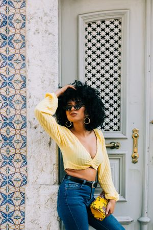 Fashionable female by gray door