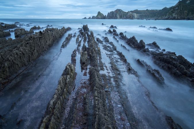Foggy landscape of Playa de Gueirua rock seashore