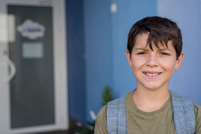 Portrait of smiling boy standing in school