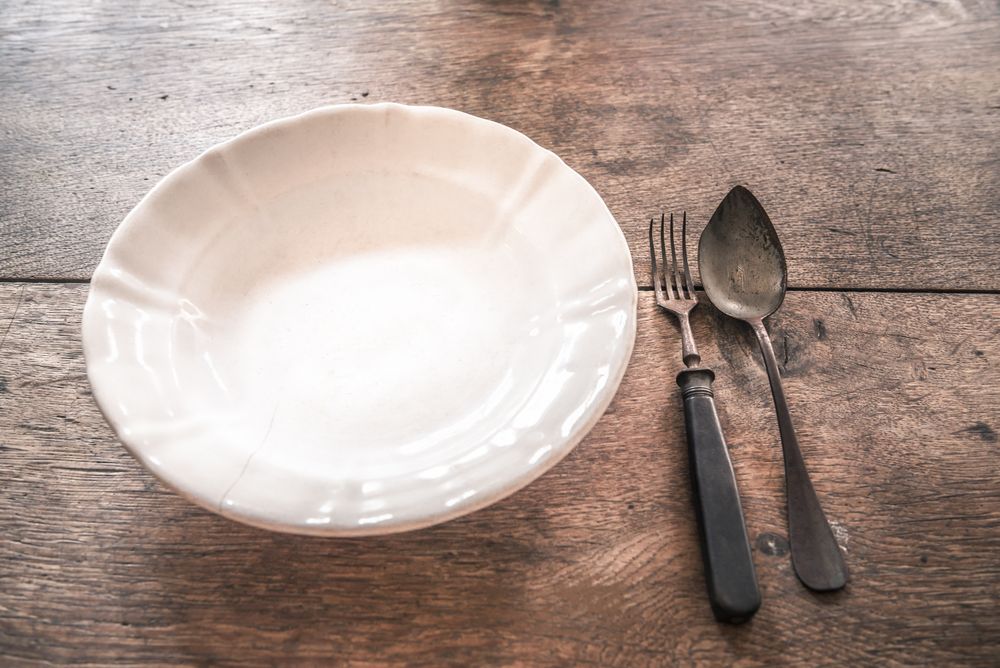 Rustic weathered tableware on wooden table