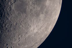 Moon surface close-up highlighting craters and rugged lunar terrain.