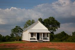 Cream rustic house with clouds in background in Alabama A0ywj4