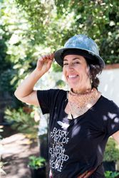Woman smiling in hard hat outside