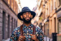 Stylish Black man walking on the city street