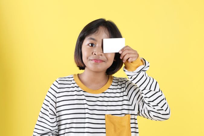 Asian Kids Holding Empty Bank Card for Close One of Her Eye