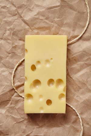 Top view of cheese on paper with string