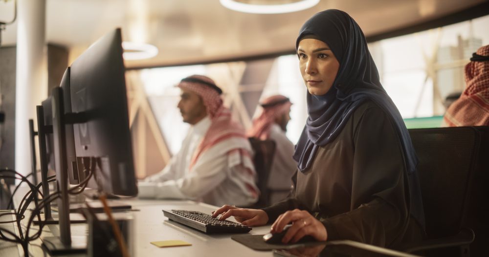 Portrait of a Young Muslim Female Working with a Talented Team of Male Professionals in a Technological Research and Development Agency.