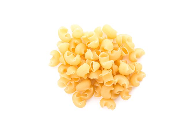 Pasta isolated on light background, top view. Traditional shape of dry uncooked whole pasta